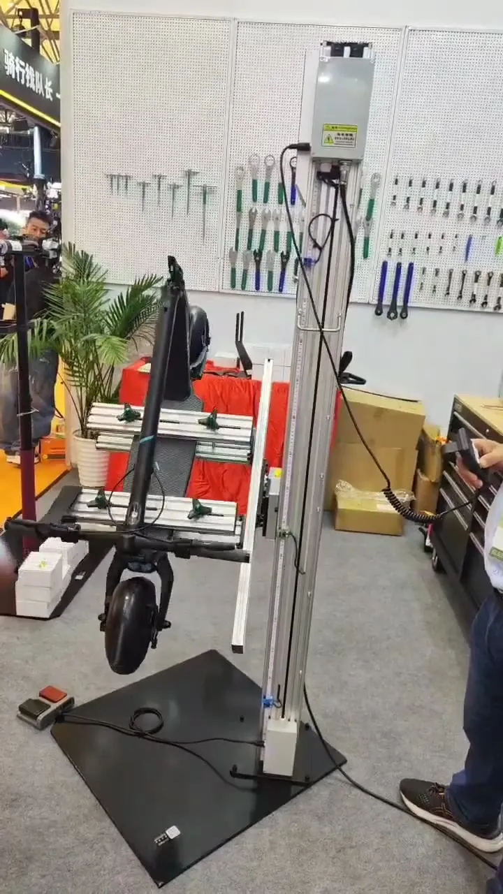 Trade-show demonstration — the scooter lifted smoothly on the platform cradle